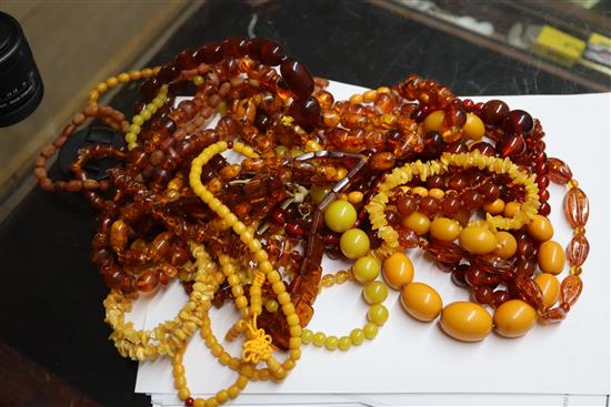 A quantity of amber and faux amber bead necklaces.